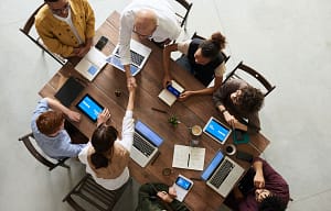 Top down view of a team sitting at a table