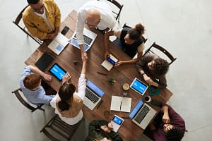 Top down view of a team sitting at a table